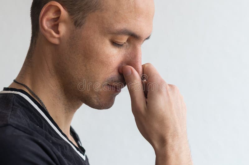 Man Smells Something Stinky And Pinches His Nose To Stop The Bad Odor