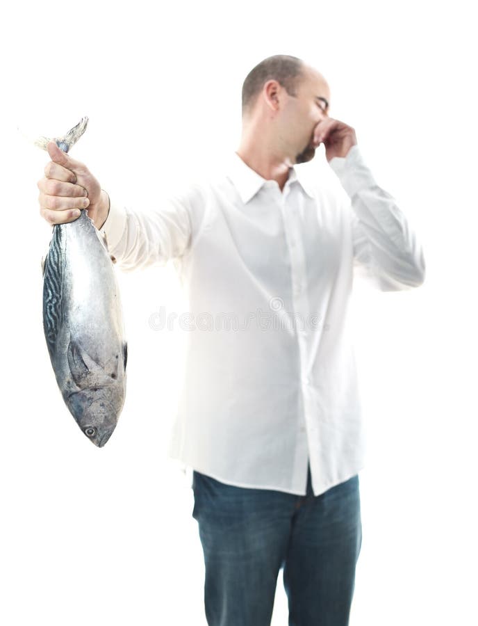 Man with smelly fish stock photo. Image of hand, fisherman 16073478