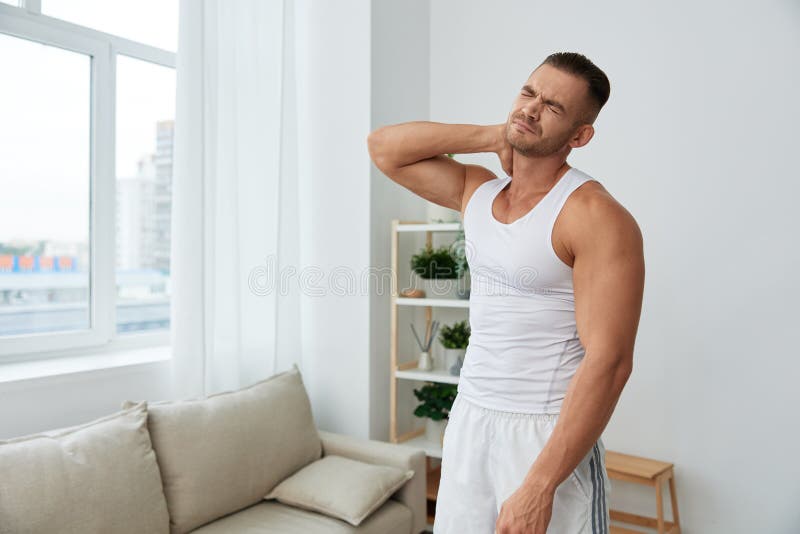 Man sports neck and back pain after working out at home, the concept of health and body beauty. High. Man exercised stock images, royalty-free photos and pictures