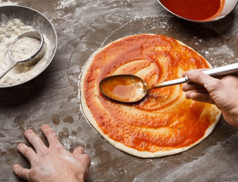Man Spreading Tomato Paste on Pizza Base Stock Photo Image of cooking