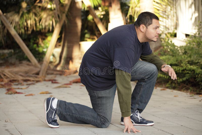 Man in a squatting pose stock photo. Image of composition 20185220