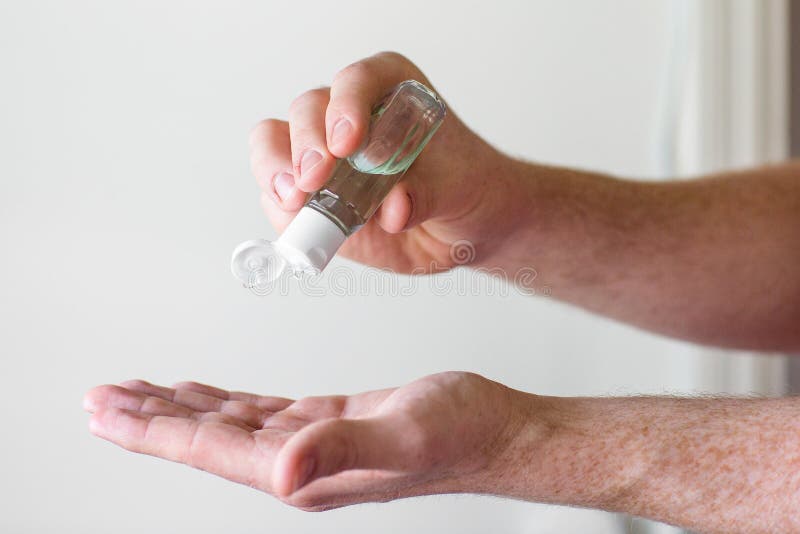 Man Squirting Hand Sanitizer into Hand