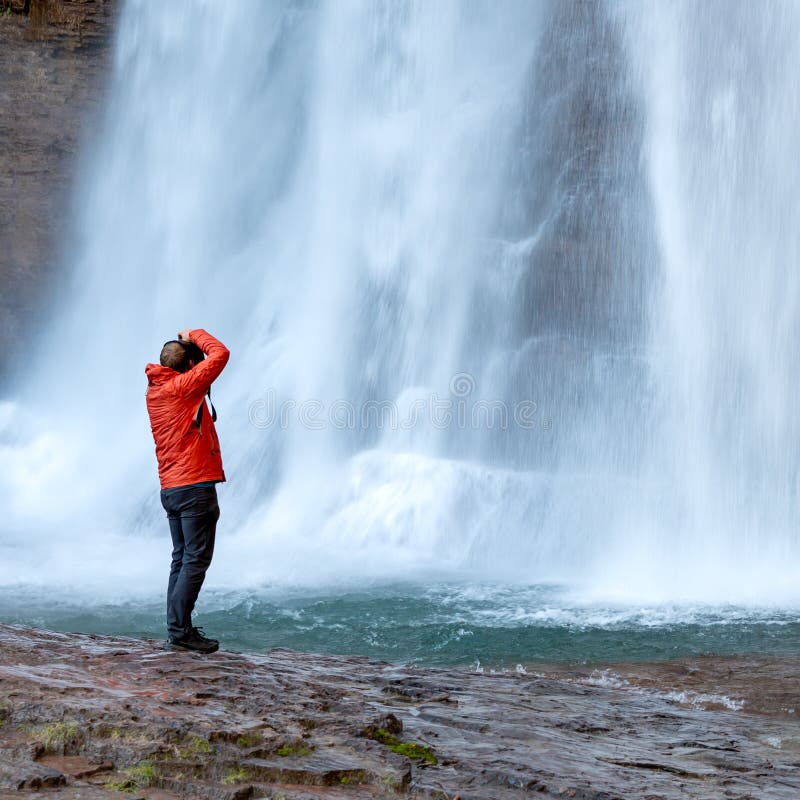 Man Standing Below Waterfall Stock Image Image of background