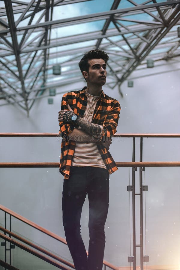 Man Standing on Brass Railing Looking Sideways stock images