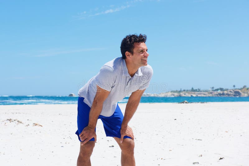 Man Standing with Hands on Knee at the Beach Stock Image Image of