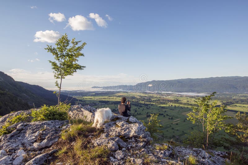 Man standing at the top of the hill and taking photos.