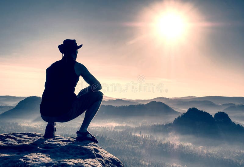 Man standing on the top of mountain. Amazing view, tourist, tourism, success, sportswear, sky, side, rock, -, object, remote, recreational, pursuit, people, peak, outdoors, one, person, range, climbing, morning, men, looking, lifestyles, landscape, scenery, horizontal, hiking, high, up, fog, fear, enjoyment, energy, efficiency, edge, day, danger, crazy, copy, space, contemplation, confidence, cliff, chinese, ethnicity, china, east, asia, casual, clothing, blue, balance, arms, akimbo, adventure, adults