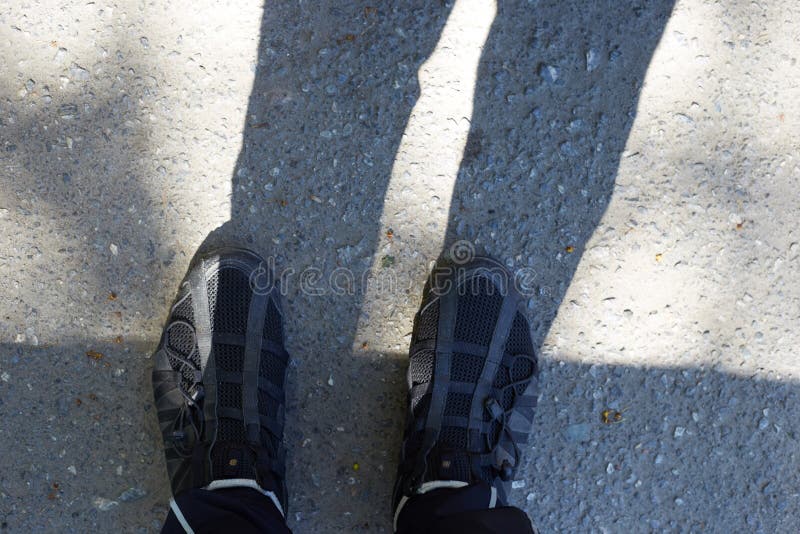 A Man Stands on the Asphalt Photo of His Feet in Shoes with Shadows ...