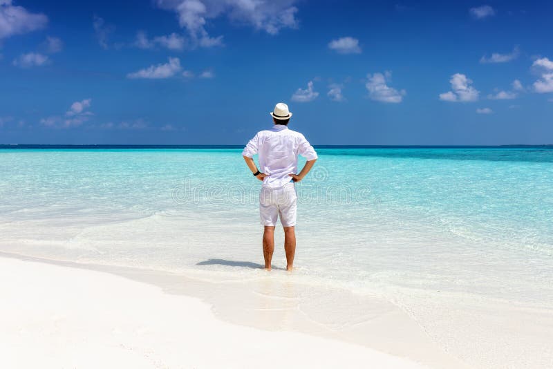 Man Stands On A Tropical Beach And Enjoys His Summer Stock Image