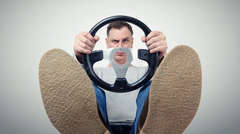 Man with a steering wheel, front view. Driver car concept stock images