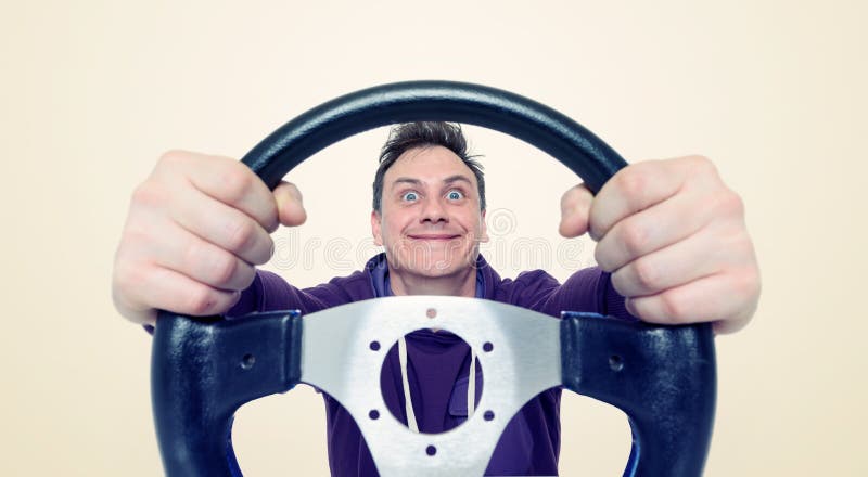 Man with a steering wheel, front view. Driver car concept royalty free stock photos