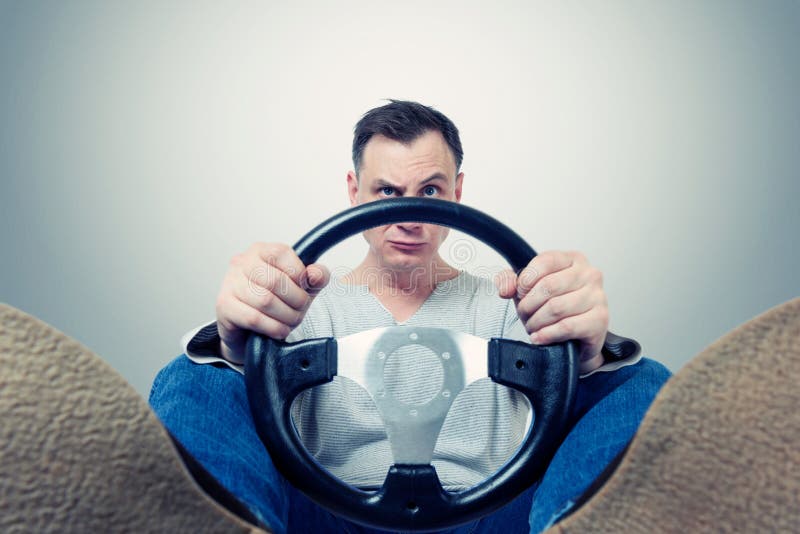 Man with a steering wheel, front view. Driver car concept royalty free stock images