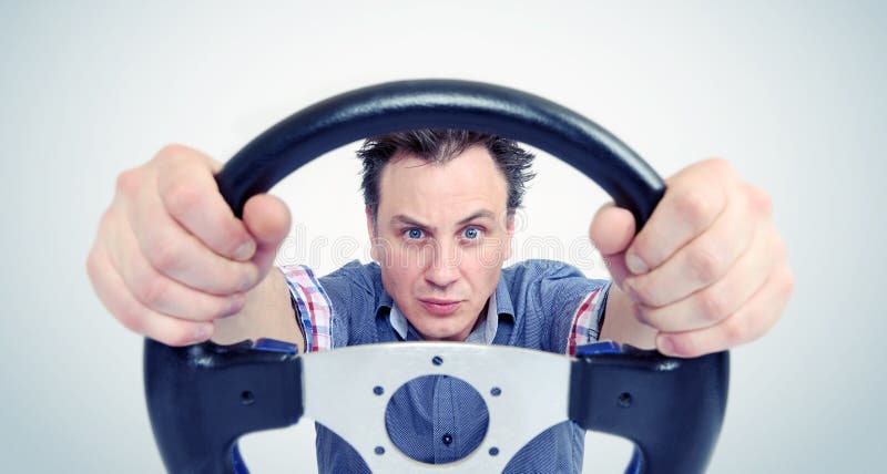 Man with a steering wheel, front view. Driver car concept royalty free stock photography