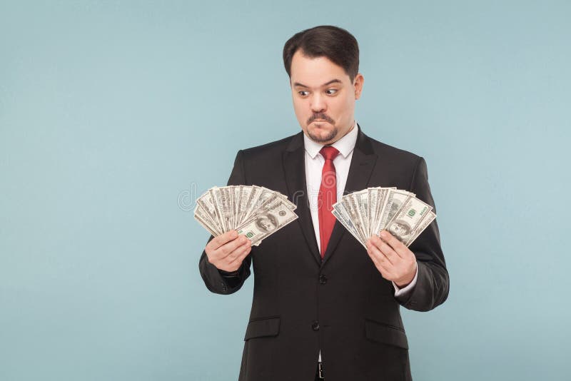 Man in stress holding many dollars