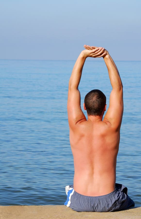 Man stretching on sunbed