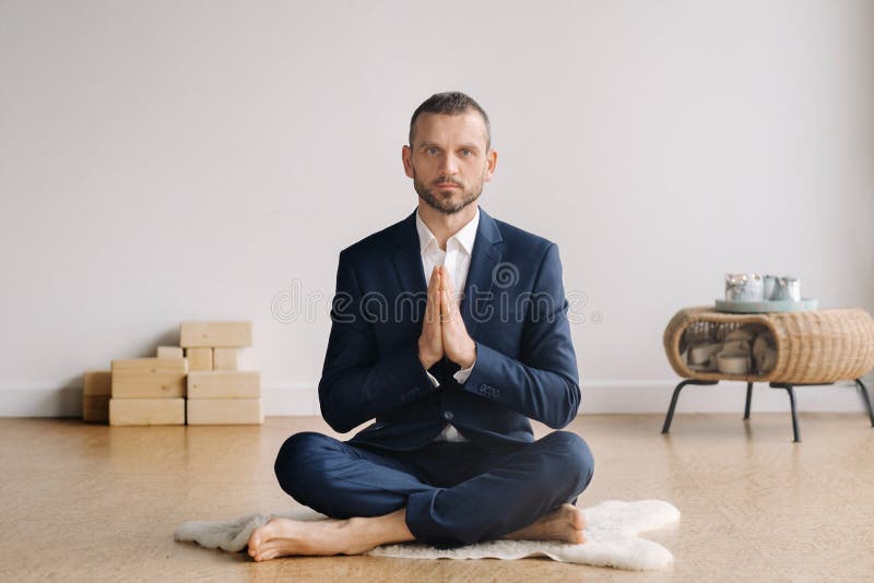 A Man in a Strict Suit Does Yoga while Sitting in a Fitness Room Stock ...