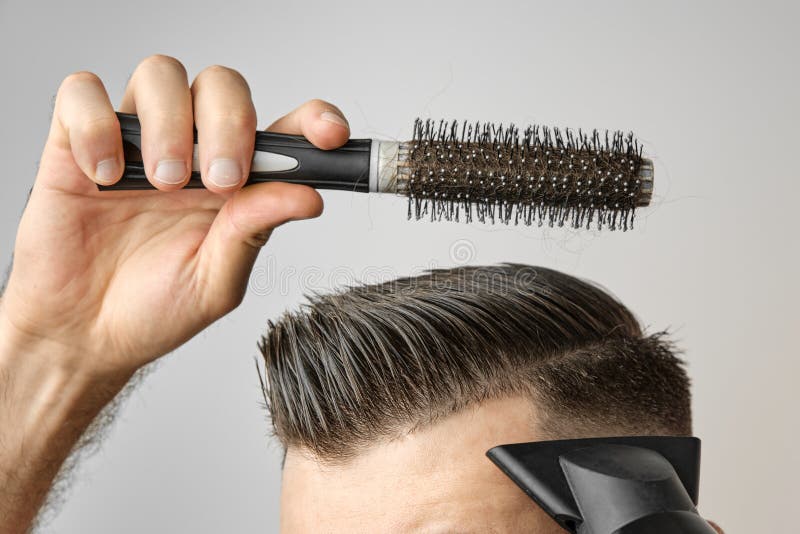 Man Styling His Hair with Hair Dryer and Round Brush. Hair Care at Home  after Barbershop Stock Photo - Image of forehead, beauty: 195614948