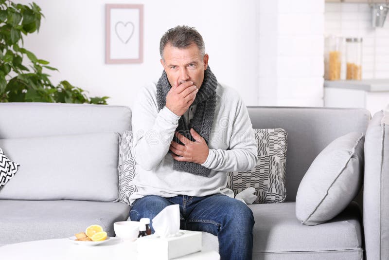 Man Suffering from Cough and Cold on Sofa Stock Photo Image of
