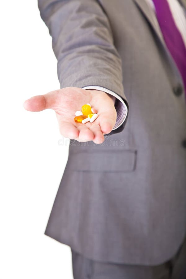 Man in suit holding pills isolated