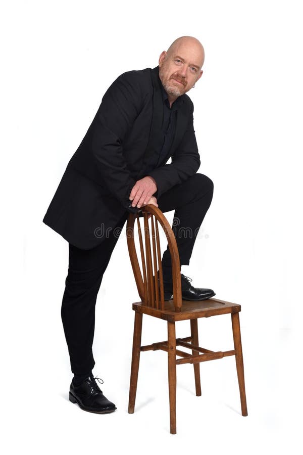 Serious Man In Beige Hat Standing On Chair With One Leg Stock Photo Image  Of Male, Business: 139304292
