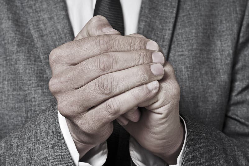 Man in suit rubbing his hands