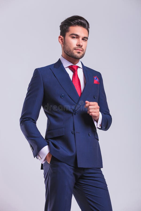 Man in Suit Standing in Studio Posing with Hand in Pocket Stock Photo