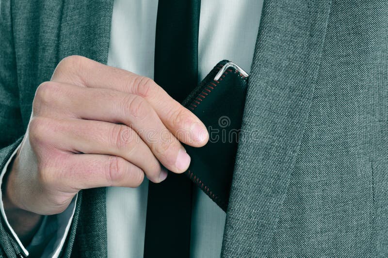 Man in suit taking out his wallet