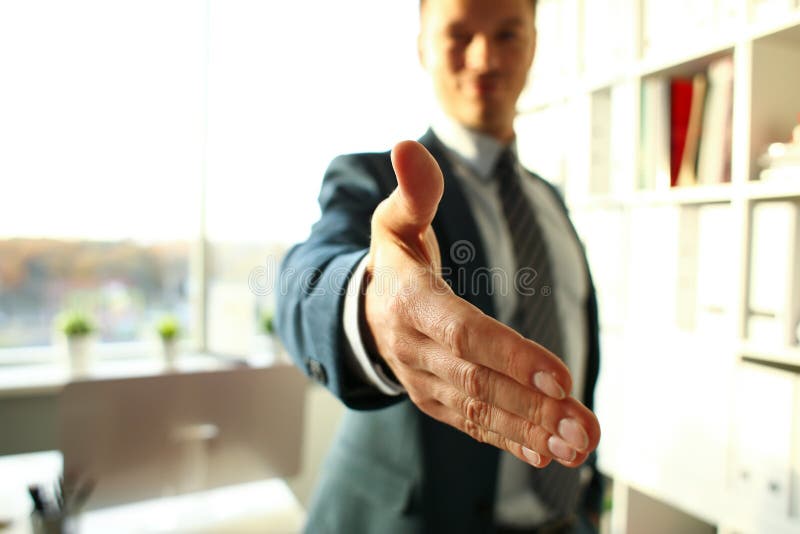 Man in suit and tie give hand as hello stock photo Man in suit and tie give hand as hello stock photo