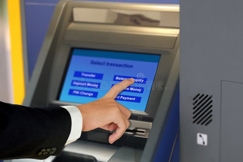 Man in suit touching display screen at ATM terminal royalty free stock photography