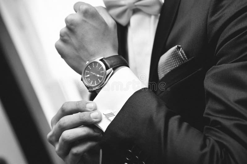 Man with suit and watch on hand