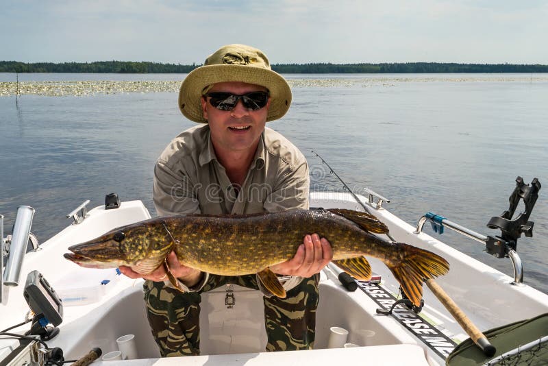 Man with summer pike fish