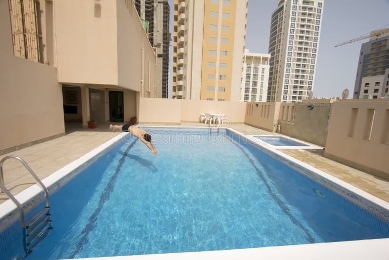 Man swim in swimming pool at roof of apartment, bahrain. Man swim in swimming pool at roof of apartment, bahrain