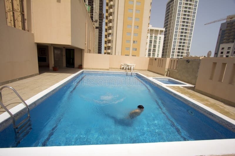 Man swim in swimming pool at roof of apartment, bahrain. Man swim in swimming pool at roof of apartment, bahrain