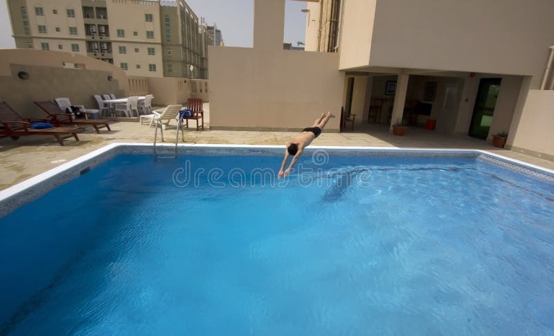 Man swim in swimming pool at roof of apartment, bahrain. Man swim in swimming pool at roof of apartment, bahrain