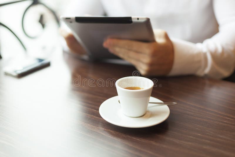 Man with tablet computer reading news at motning