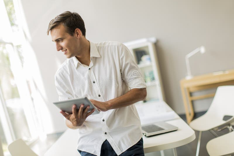 Man with tablet in the office stock photos