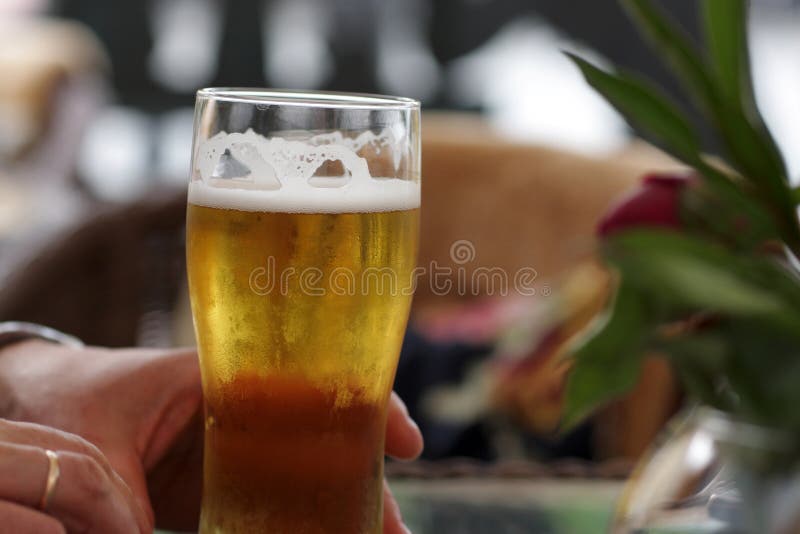 Man takes glass of beer