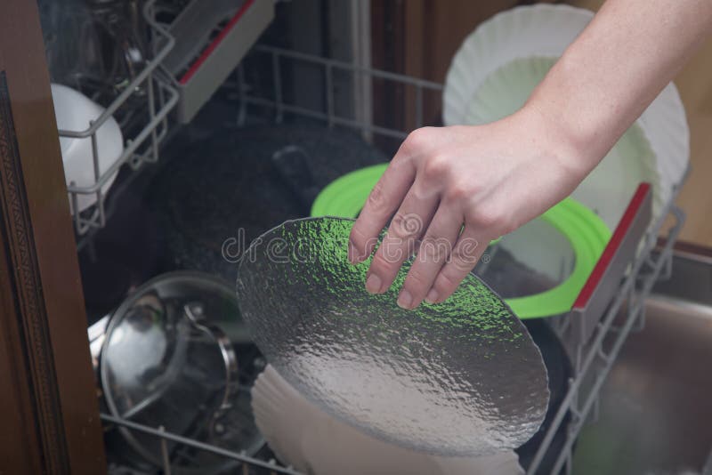 A Man Takes Out Clean Dishes from the Dishwasher Stock Image Image of lifestyle, housework
