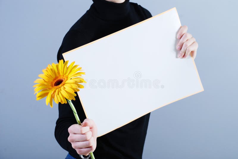 Man takes placard and flower