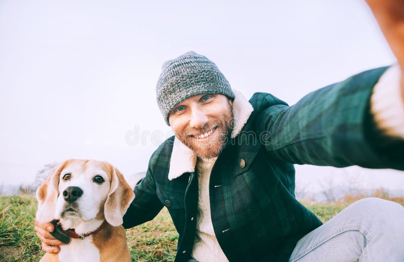 Man takes selfie photo with his best freind beagle dog