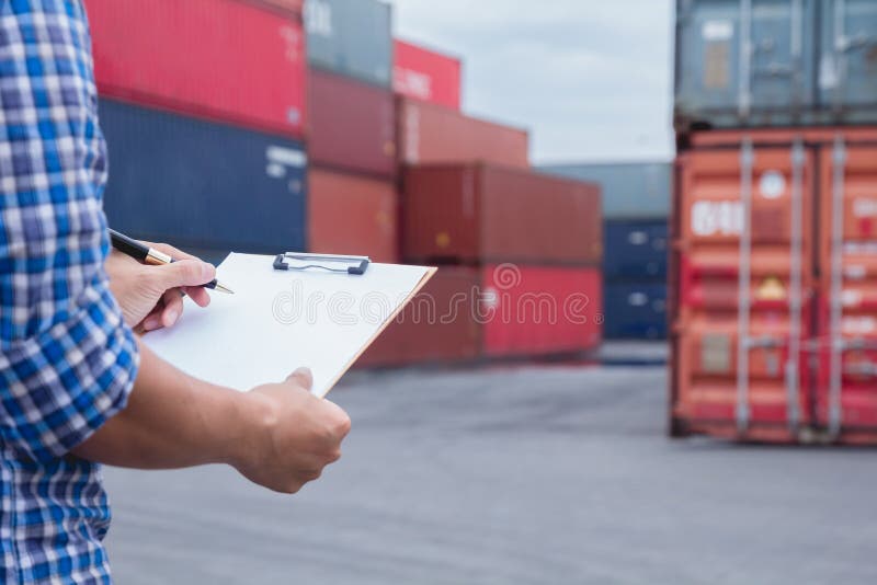 Man taking note checking cargo shipping at container yard area. royalty free stock images Man taking note checking cargo shipping at container yard area. royalty free stock images