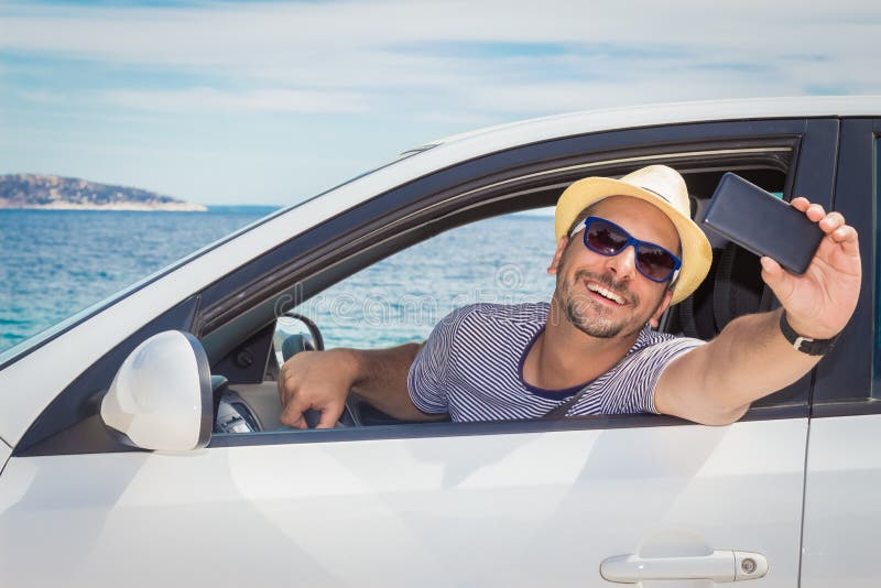 selfie of man holding his drivers lisense selfie of man holding his drivers lisense