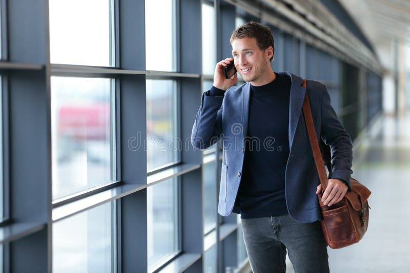 Smartphone business man talking on mobile phone in airport - travel lifestyle. Businessman using smartphone calling on phone walking in corporate building or on work commute in public transit area. Smartphone business man talking on mobile phone in airport - travel lifestyle. Businessman using smartphone calling on phone walking in corporate building or on work commute in public transit area.