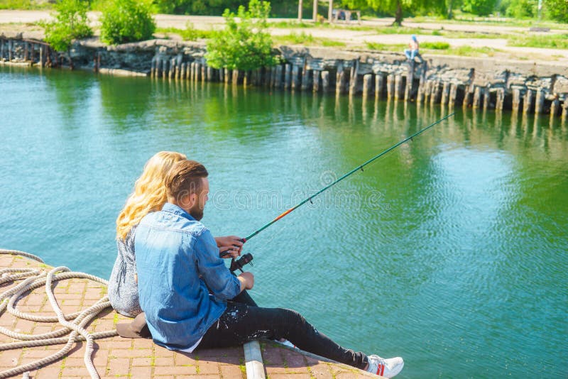 Man Teaching His Girlfriend To Fishing. Date, Love and Hobby Concept ...