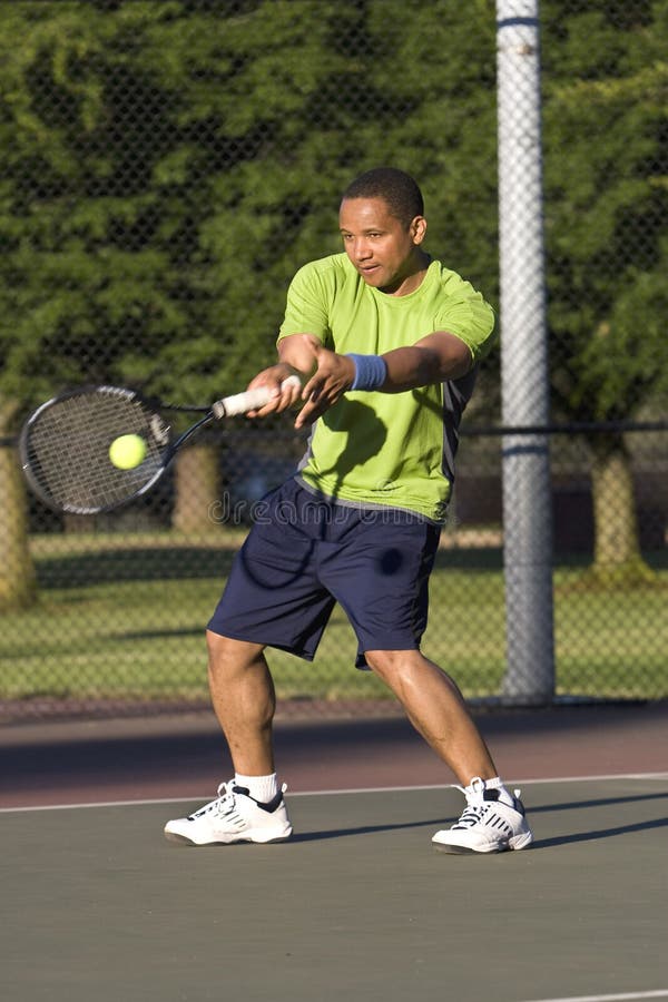 Man on Tennis Court Playing Tennis - Vertical