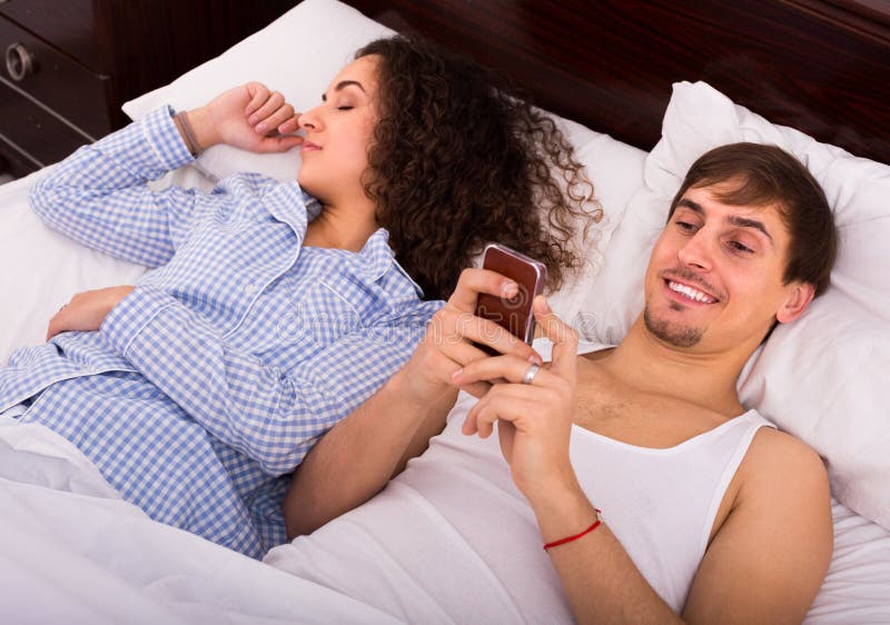 Man Texting To Lover As Wife Sleeping Stock Photo - Image of