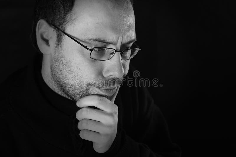 Man thinking with beard and glasses