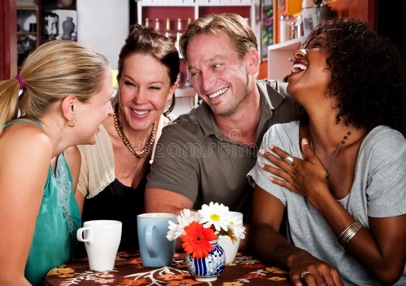 Man with three pretty women in coffee house