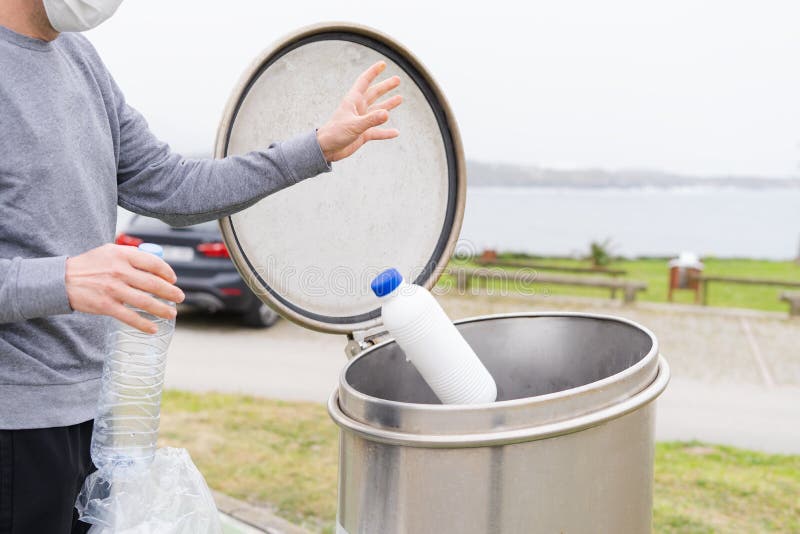 Man throwing plastic containers at recycling point. Social responsibility. Recycling concept royalty free stock photography