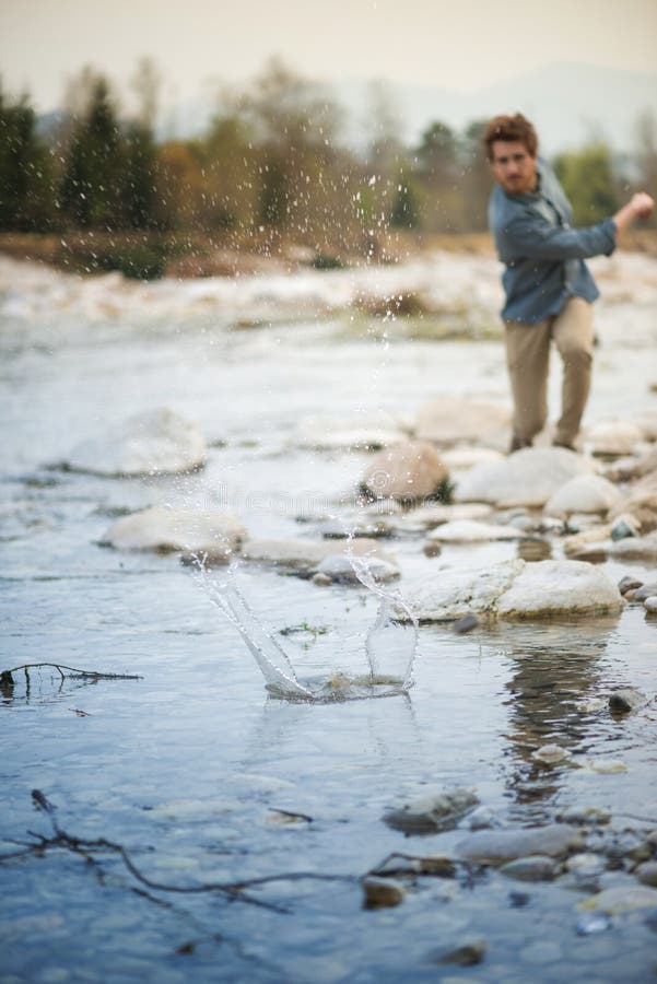 Man Throwing Stones in the River Stock Photo Image of casual, nature
